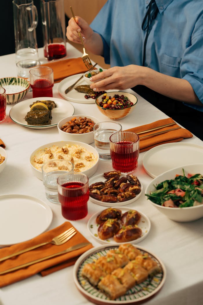 A colorful spread of traditional Turkish cuisine featuring various dishes and a person enjoying the meal.