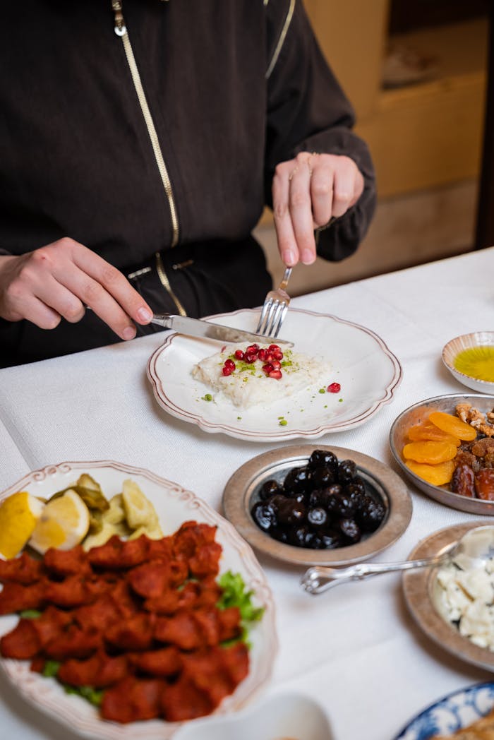 An elegant table setup featuring a variety of Turkish mezze dishes alongside rice garnished with pomegranate.